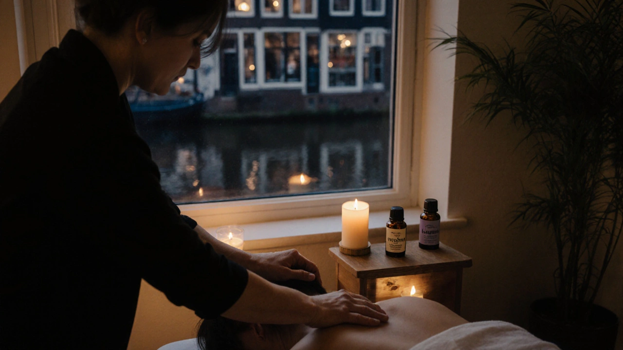 Therapist performing gentle myofascial release in a quiet Amsterdam studio with essential oils nearby.