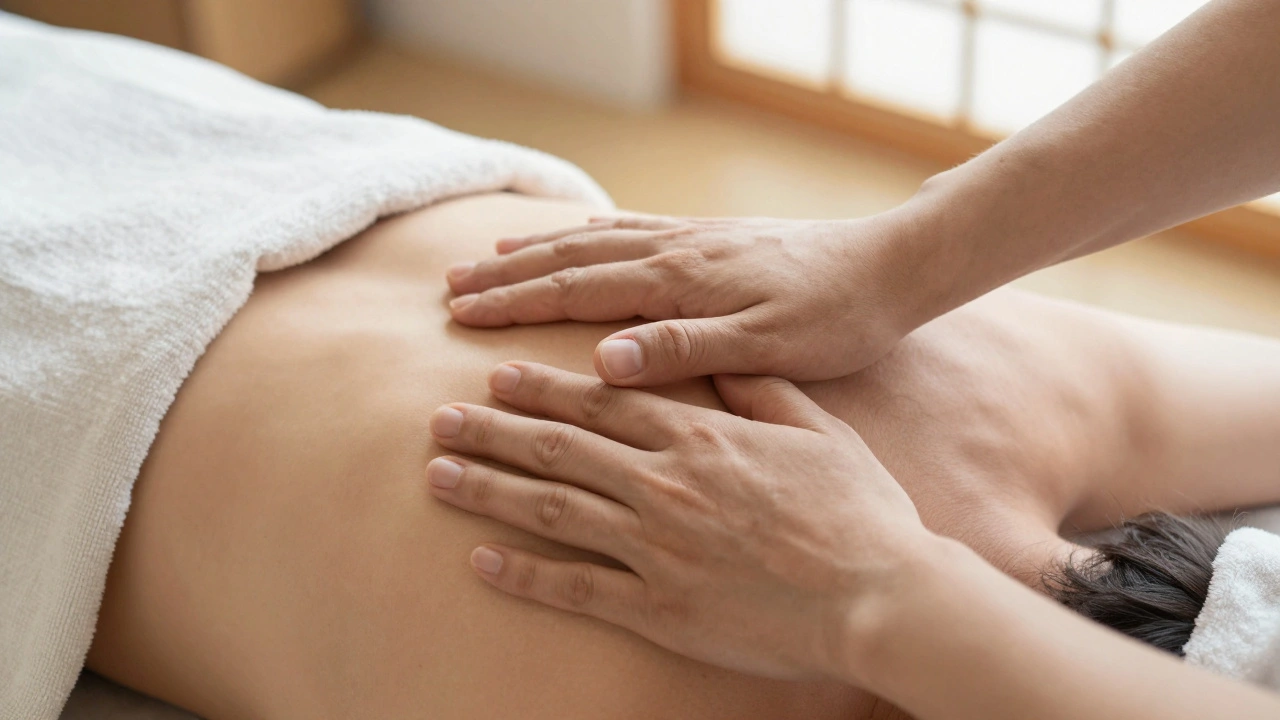 Close-up of hands performing tuina techniques — rolling, pressing, and grasping — on a client's shoulder and neck.